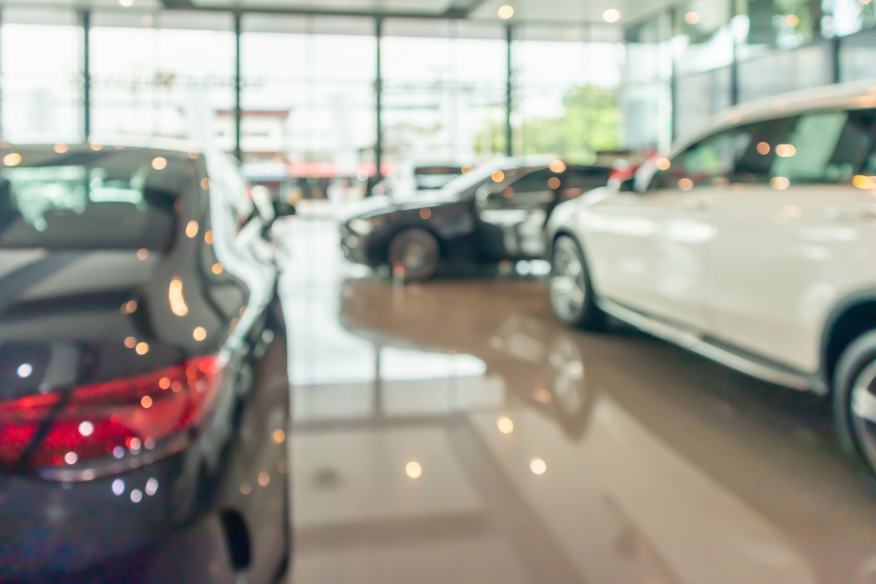 New Cars In Showroom Interior Blurred Abstract Background
