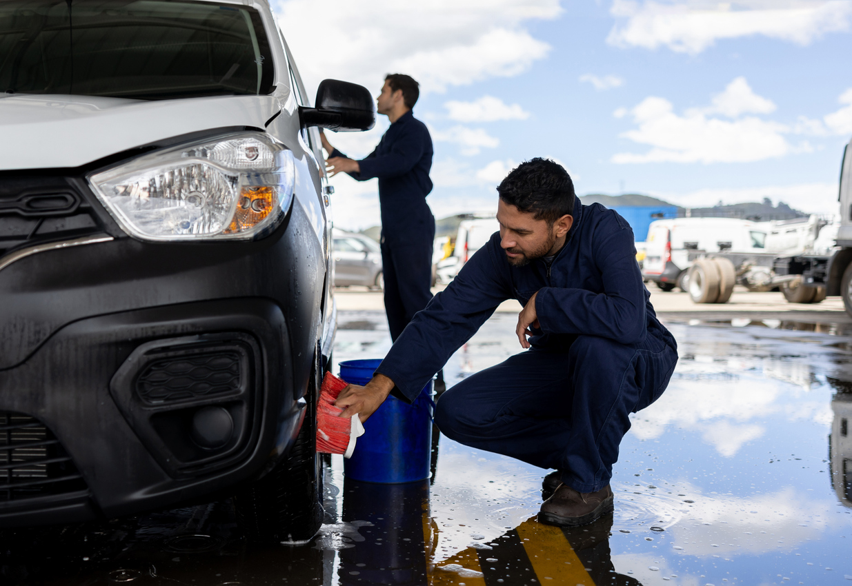 Men Working At A Car Wash Cleaning A Vehicle