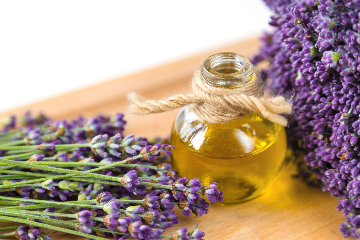 Fresh Lavender Flowers And Oil On Wooden Background