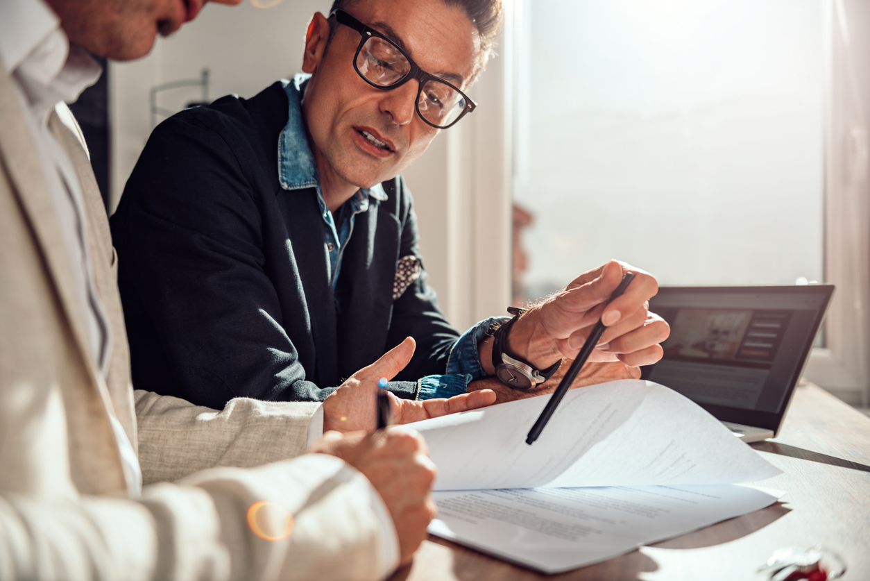 Businessman Pointing Where Client Have To Sign The Contract